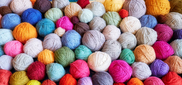 Colorful background made of wool yarn balls. stock photo
