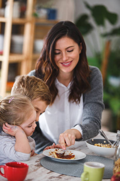 istock Mother cutting up her daughter's breakfast 1145175027