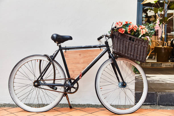 istock Vintage bicycle with basket against white wall background. Close-up 1145175102