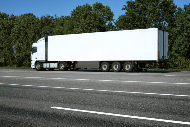istock White truck is going up the road. Cargo transportation concept. 1145175229