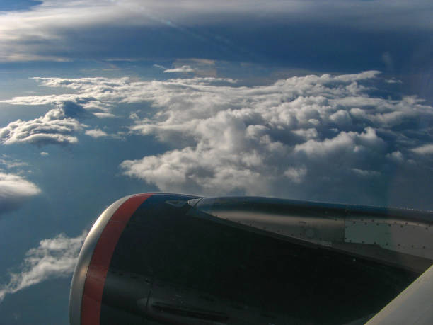 View From Commercial Jet Window of Wing, Clouds and Tuscan Landscape Near the Medieval City of Florence Italy
