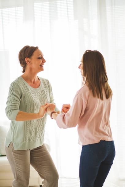 istock Mother and daughter having fun dancing 1145177726