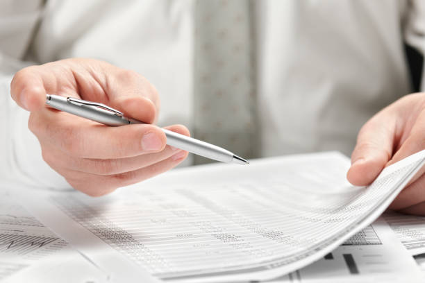 istock Businessman working in an office. Hands and documents closeup. 1145177988