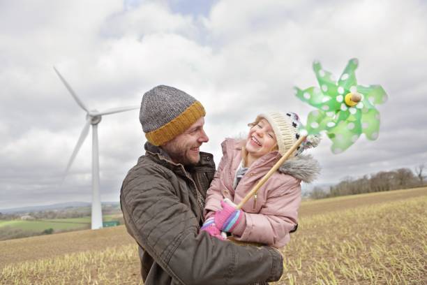 istock Father and daughter walk to wind turbine 1145178664