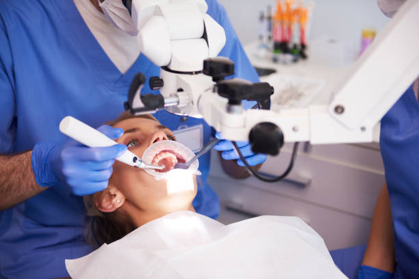 young woman at the dentist - dentist office dentists chair dental equipment white imagens e fotografias de stock