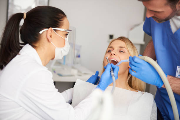 Two dentists doing their work in dentist's clinic Two dentists doing their work in dentist's clinic dental drill stock pictures, royalty-free photos & images