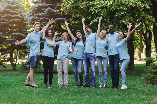 istock Group of young volunteers embracing at park 1145183126