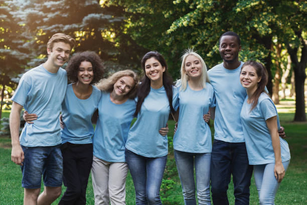istock Group of young volunteers embracing at park 1145183127