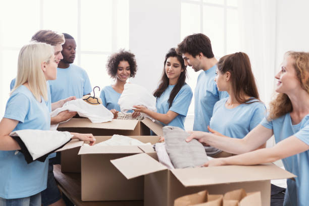 istock Young volunteers group working with clothing donation 1145183207