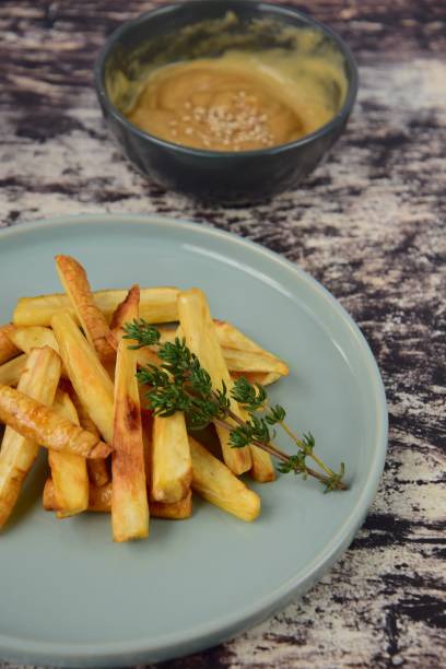 istock Roasted parsnip garnish with thyme served with tahini dip 1145183766