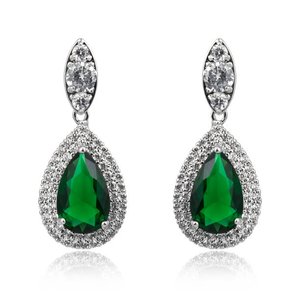 Pair of emerald earrings isolated on white background Pair of emerald earrings isolated on white background stone object stock pictures, royalty-free photos & images