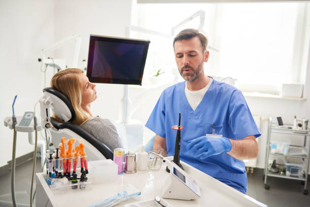 istock Male dentist doing him work in dentist's clinic 1145186850