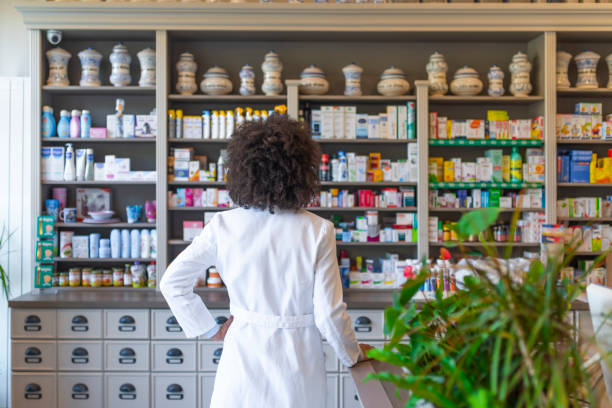 istock Rear view of Woman working at pharmacy 1145189084