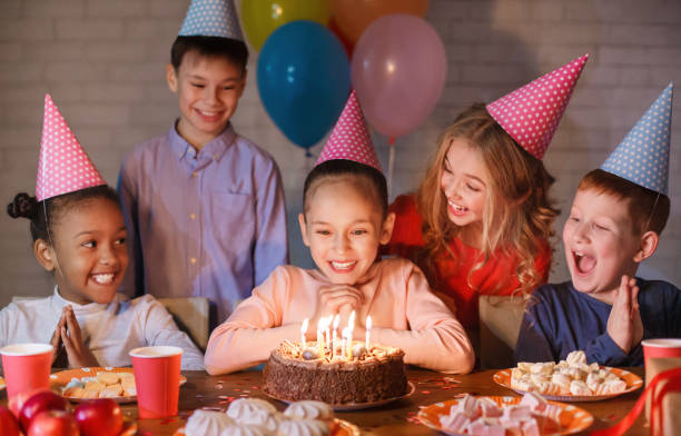 istock Girl looking at birthday cake with candles 1145190095