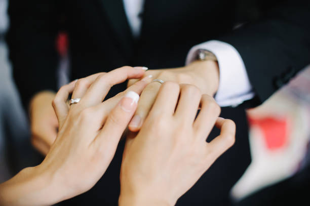 istock Bride putting on a wedding ring for bridegroom 1145191006