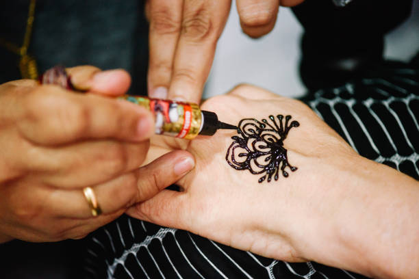 istock Artist drawing henna tattoo on hand 1145191954