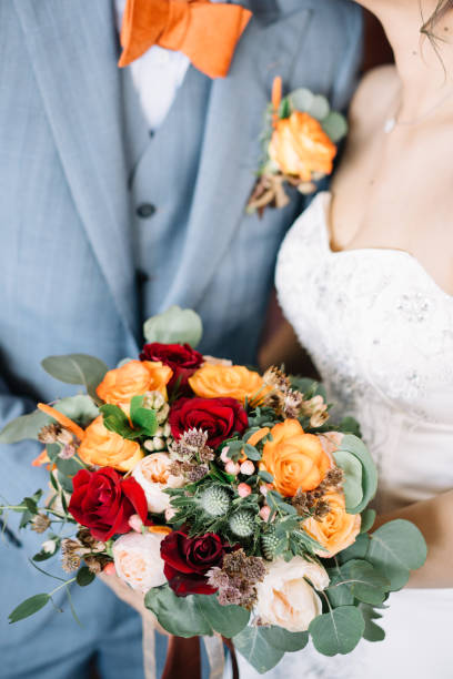 istock Bride and bridegroom holding flower bouquet 1145192044