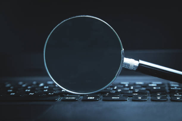 istock Magnifier on laptop keyboard. Searching on internet 1145193938