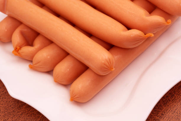 istock raw sausages isolated on white background Top view 1145195157