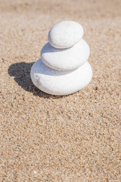 istock stack of pebble stones on balance on a sandy beach with copy space 1145196116