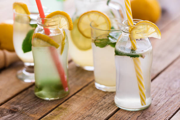 Fresh made lemonade, with kiwi fruits and mint leaves, cooled in fridge, in glass, close up