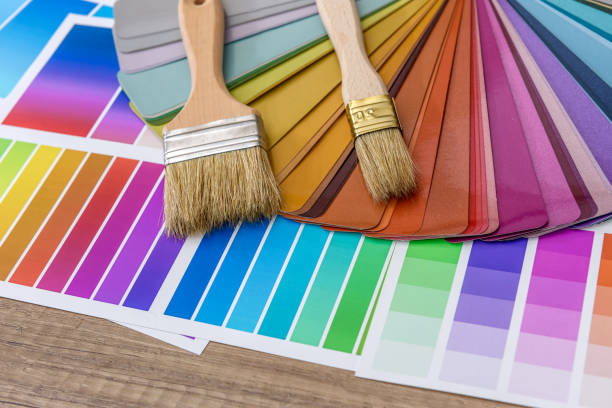 istock Brushes and paint color palette samples on wooden background, closeup 1145199702