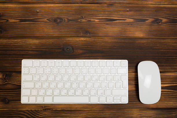 istock Modern  keyboard on the wooden table with mouse  in the office - Image 1145204032