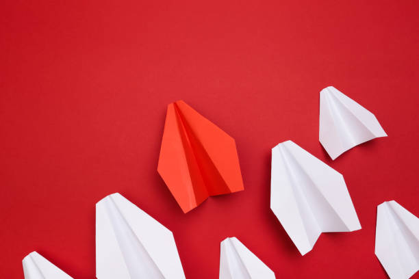 istock winner red  paper aircraft on red background - Image 1145204210
