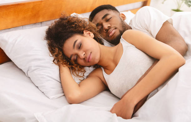 istock Loving couple sleeping in bed and hugging 1145204241