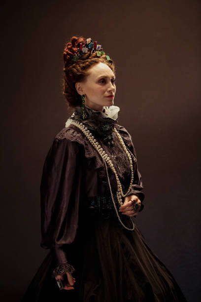 Elegant Fashion Queen Elizabeth I concept. The woman portraying her is dressed traditionally but with little images of app icons scattered in her hair. She is facing away from the camera standing confidently. elizabeth i of england photos stock pictures, royalty-free photos & images