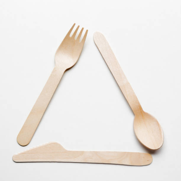 istock Wooden single use kitchenware in shape of Universal Recycling Symbol on white background. Top view 1145204482