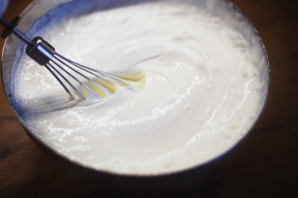 cream is whipped with a mixer in a bowlcream is whipped with a mixer in a bowl