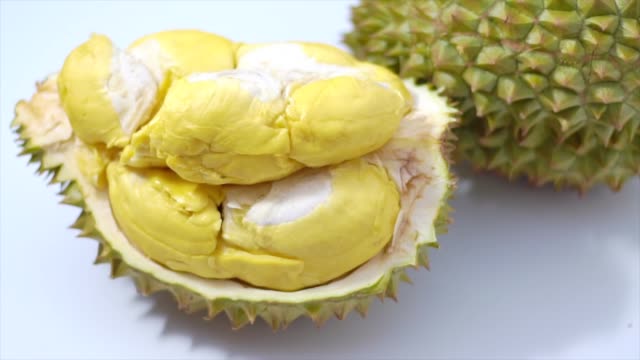 Still life photography of Durian the king of tropical fruits on white background with path, shooting in studio. Popular dessert in Thailand served with sticky rice and fresh coconut milk on topping.