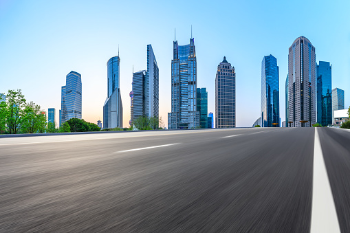 Motion blurred highway and skyline of modern urban buildings in Shanghai,China