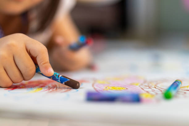 istock Close up of little hands coloring with Crayon 1145207738