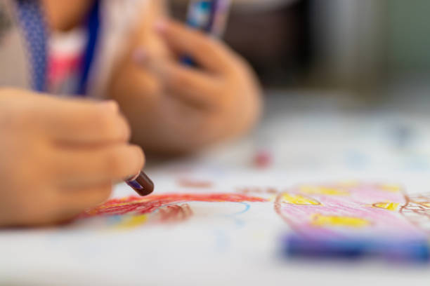 istock Close up of little hands coloring with Crayon 1145207740