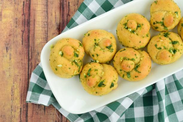 istock Garlic Knot Bread coated with Parsley Garlic Butter Sauce 1145209421