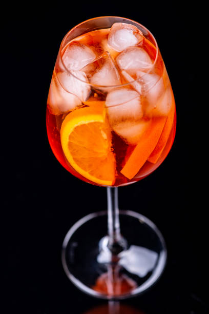 istock Spritz cocktail in glass on black reflection background. Macro. 1145212856