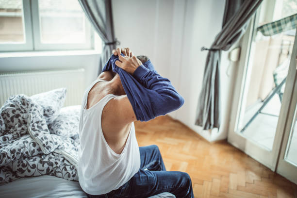 istock A man sits on the bed in the bedroom 1145214058
