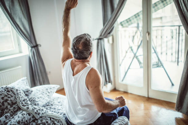 istock A man sits on the bed in the bedroom 1145214073