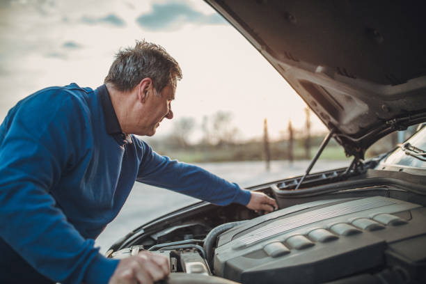 istock person with car breakdown and engine trouble 1145214787