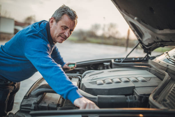 istock person with car breakdown and engine trouble 1145214839