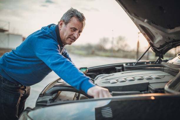 istock person with car breakdown and engine trouble 1145214953