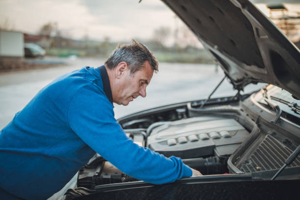 istock person with car breakdown and engine trouble 1145215166