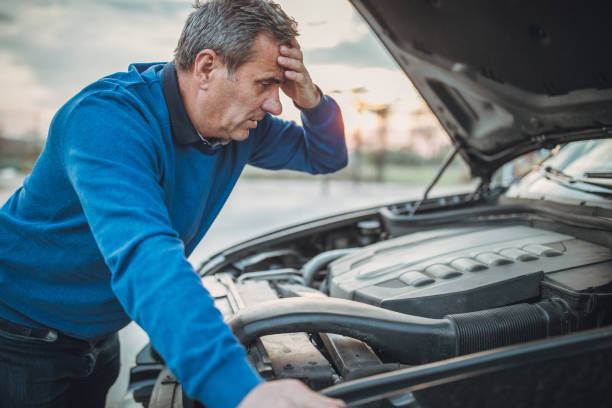 istock person with car breakdown and engine trouble 1145215336