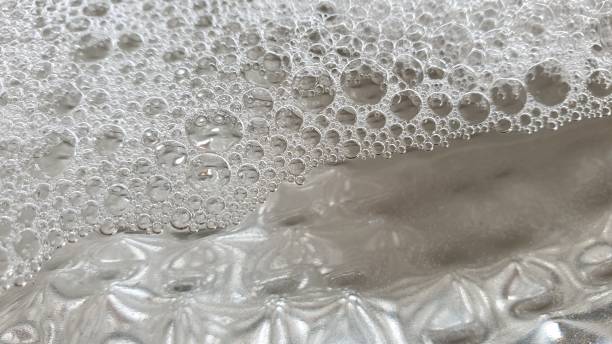 istock Soapy bubbles and reflections on metal plate 1145216135
