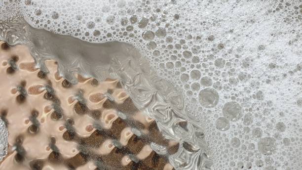 istock Soapy bubbles and reflections on metal plate 1145216148