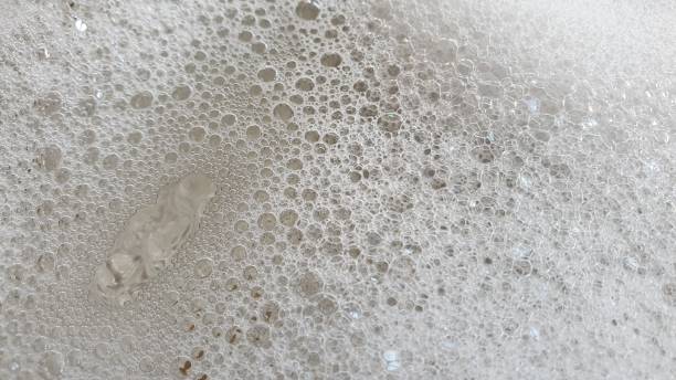 istock Soapy bubbles and reflections on metal plate 1145216158
