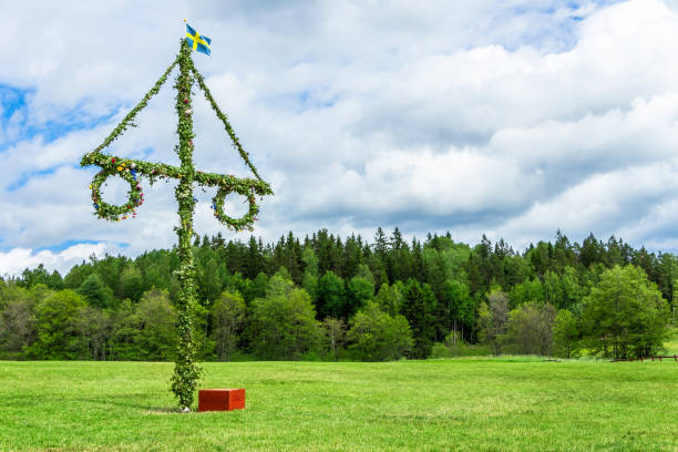 istock Midsummer celebrations with decorated Maypole on bright sunny day 1145220032
