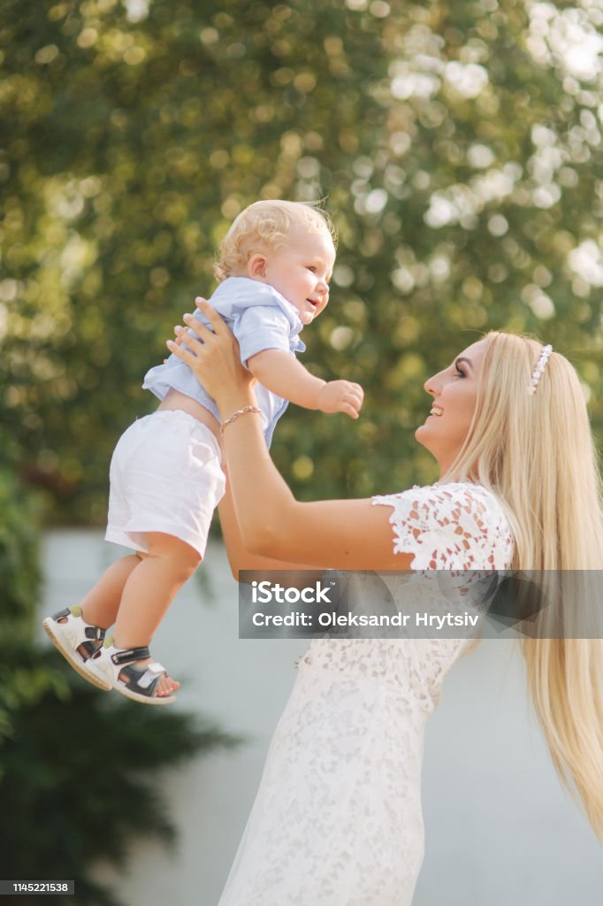 Young Blond Hair Mom Play With Son Outside Little Boy With Blond Hair Happy  Family Stock Photo - Download Image Now - iStock